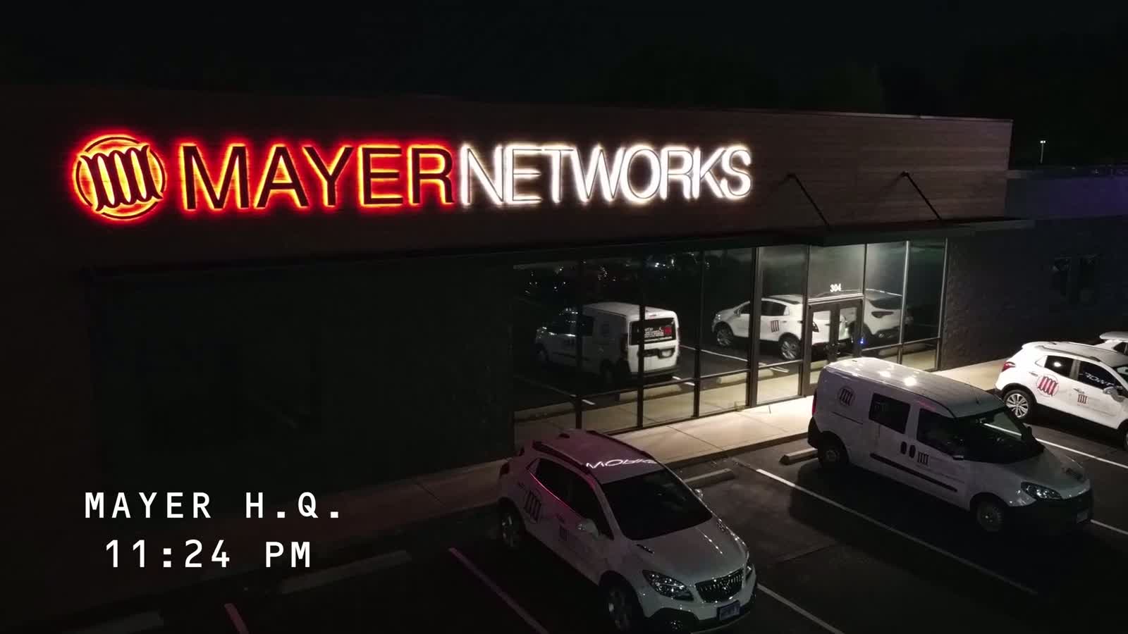 The Mayer Networks building and service vehicles in Carbondale, Illinois at night